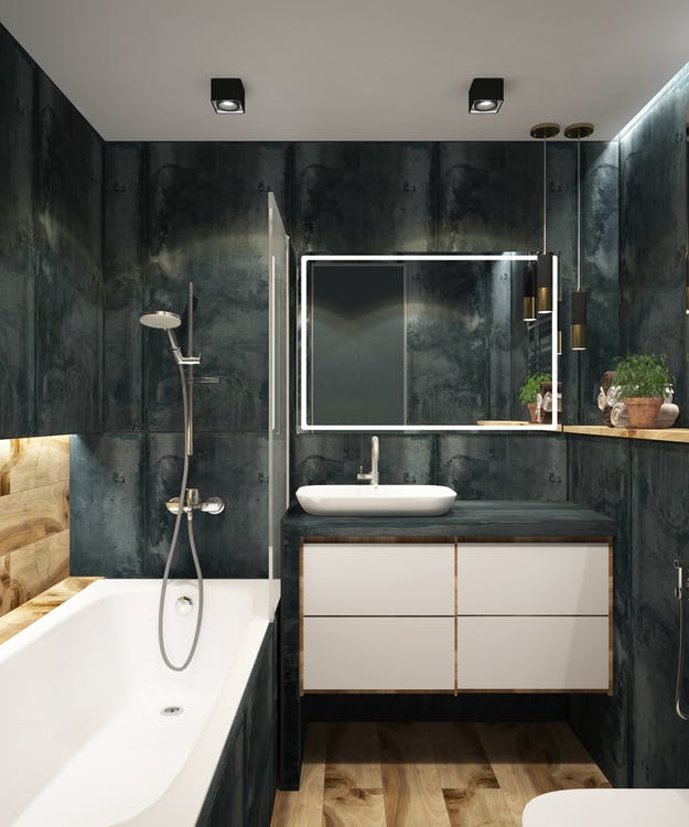  A Bathroom with a White Tub and Toilet, and a Custom Bathroom Vanity with a White Sink Bowl and Drawer and a Darker Countertop