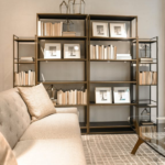 A Metal Bookshelf Adjacent to a Custom Sofa in a Carpeted Living Room