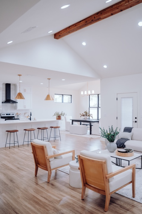 An Open Floor Interior with a Contemporary Kitchen, Living Room with Custom Sofas and Chairs, and a Dining Area