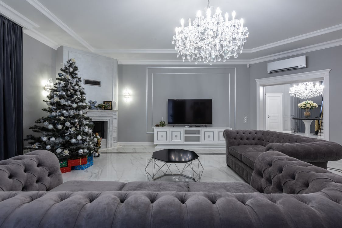 a traditional living room with gray U-shaped sofas