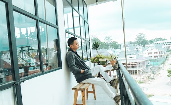 a man sitting on his balcony