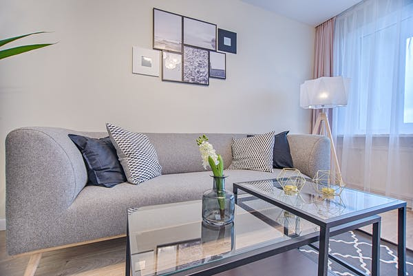 a gray sofa with blue cushions